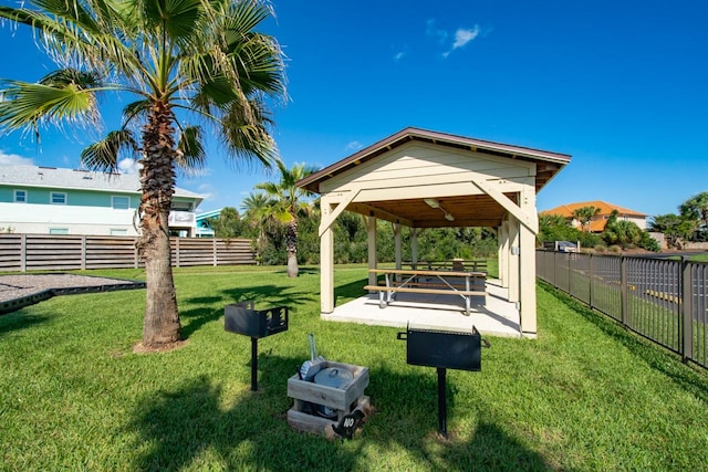 view of home's community with a patio and a lawn