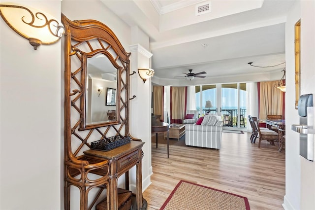 interior space with crown molding, light hardwood / wood-style floors, and ceiling fan