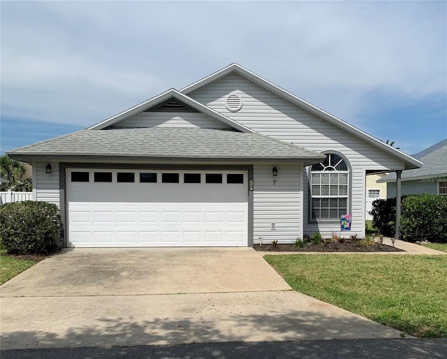 single story home with a front yard and a garage