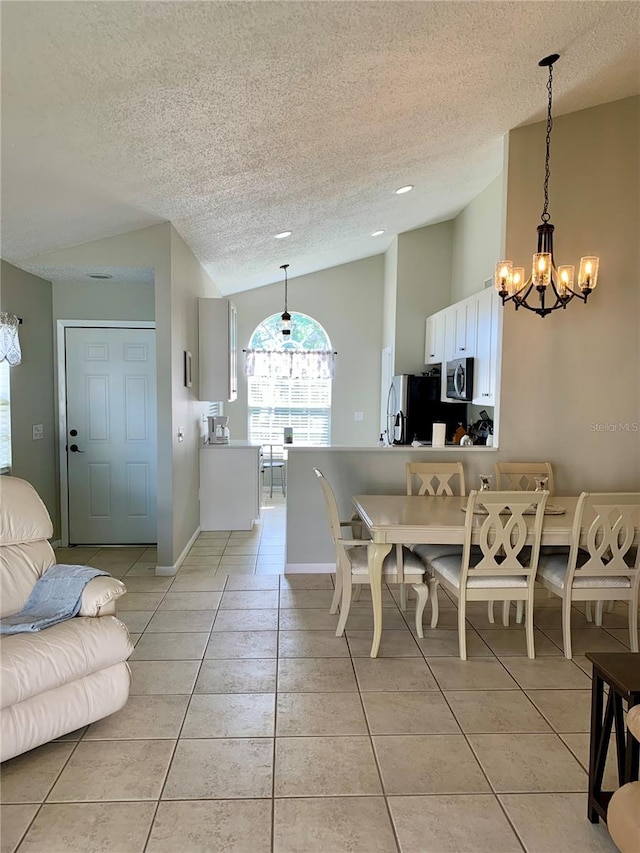 tiled dining space with a notable chandelier, lofted ceiling, and a textured ceiling