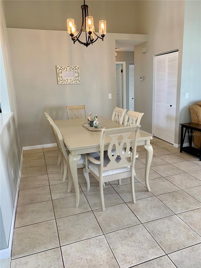 tiled dining space featuring a notable chandelier