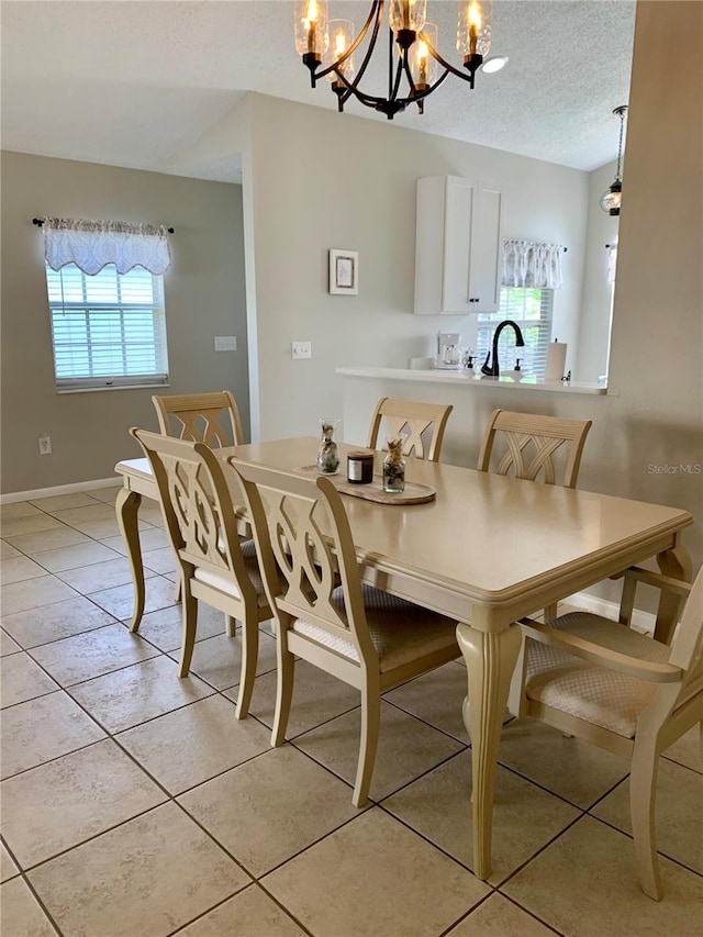 tiled dining area with a textured ceiling and a notable chandelier