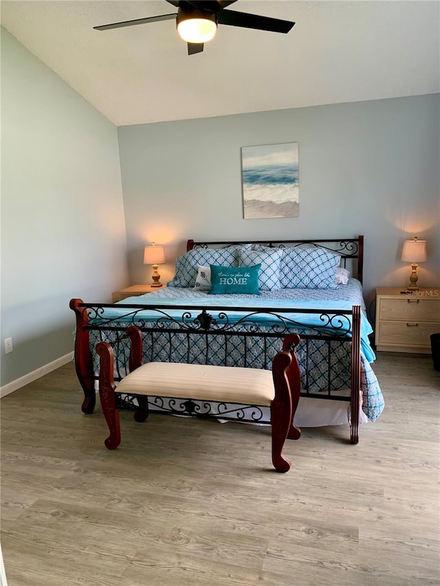 bedroom featuring lofted ceiling, hardwood / wood-style floors, and ceiling fan