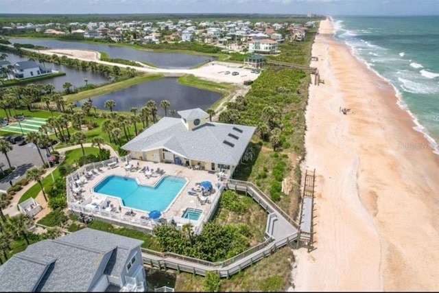 birds eye view of property with a beach view and a water view