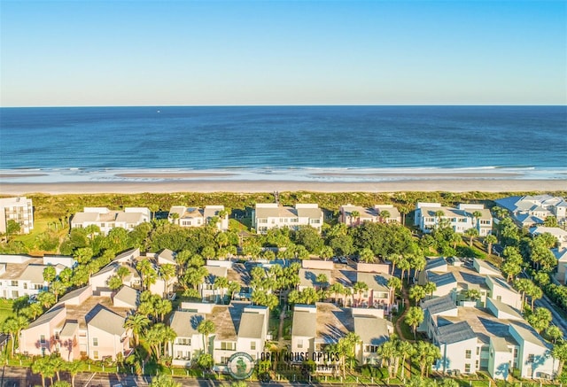 aerial view with a water view and a beach view