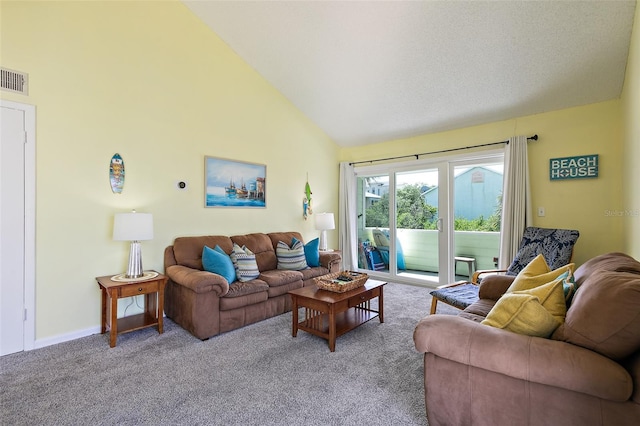 carpeted living room with high vaulted ceiling