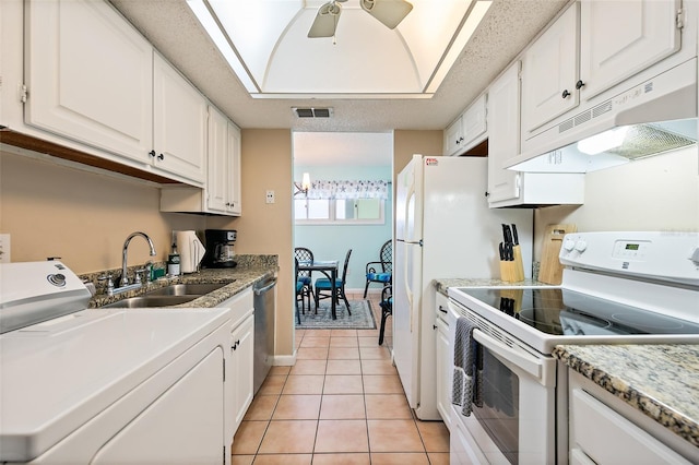 kitchen featuring ceiling fan, white range with electric stovetop, white cabinetry, and washer / dryer