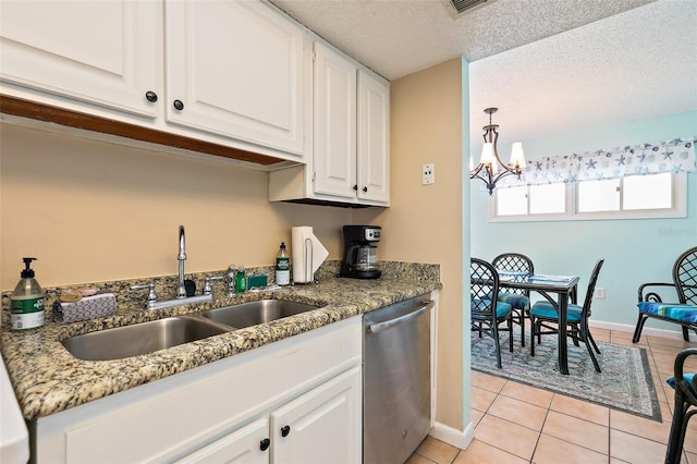 kitchen with stone countertops, light tile floors, white cabinets, dishwasher, and an inviting chandelier