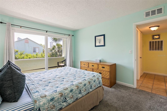 carpeted bedroom featuring a textured ceiling