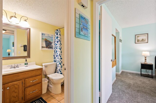 full bathroom featuring large vanity, a textured ceiling, shower / bath combination with curtain, tile floors, and toilet