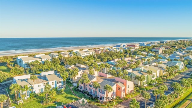 birds eye view of property with a water view and a view of the beach