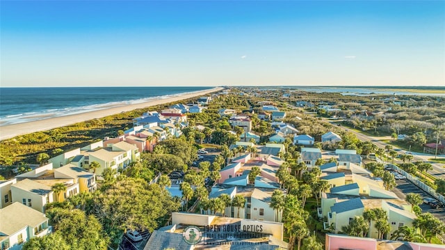 drone / aerial view featuring a water view and a beach view