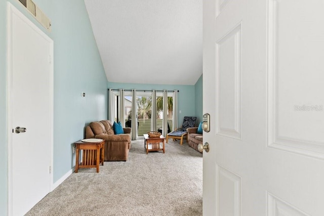 6300 A1A S Unit A44U, Saint Augustine, FL 32080 - living area with light colored carpet, vaulted ceiling, and baseboards