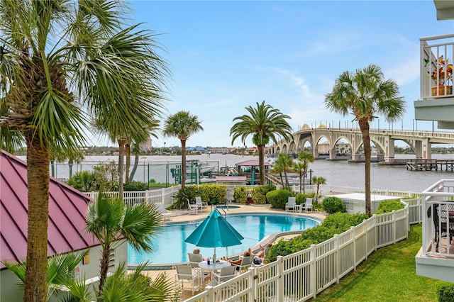 view of swimming pool featuring a water view