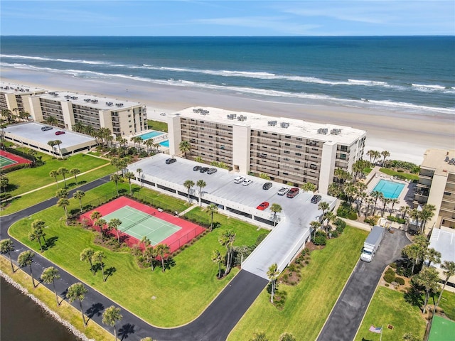 bird's eye view featuring a water view and a beach view