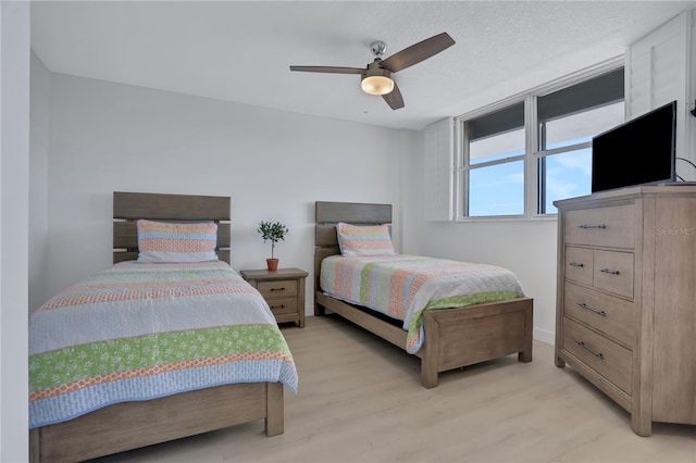 bedroom featuring light hardwood / wood-style flooring and ceiling fan