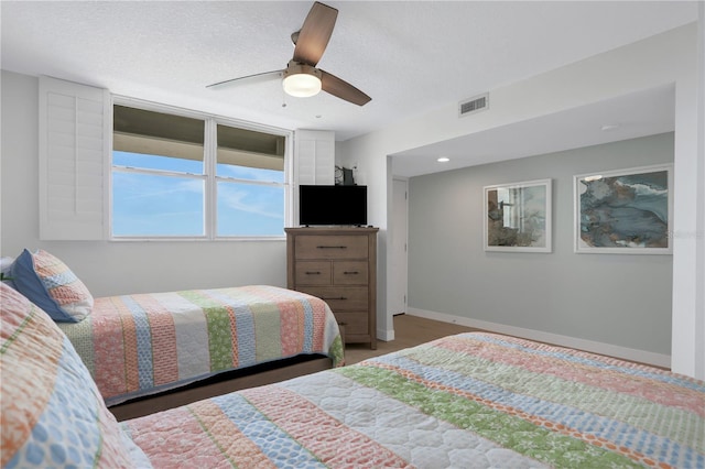 bedroom featuring a textured ceiling and ceiling fan