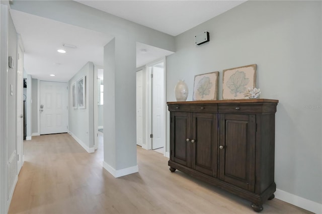 corridor with light hardwood / wood-style floors