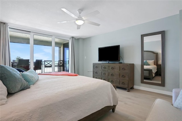 bedroom featuring light hardwood / wood-style floors, ceiling fan, and access to outside