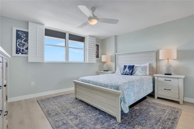 bedroom with light hardwood / wood-style floors and ceiling fan