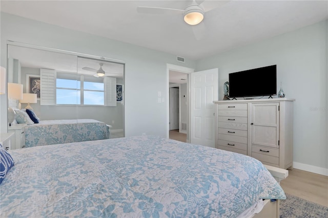 bedroom with light hardwood / wood-style flooring and ceiling fan