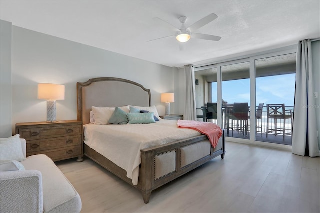 bedroom featuring floor to ceiling windows, ceiling fan, light hardwood / wood-style floors, and access to outside