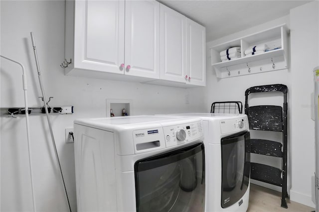 clothes washing area with light hardwood / wood-style flooring, washer and dryer, cabinets, and hookup for a washing machine