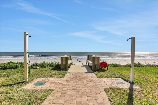 view of home's community with a water view and a view of the beach