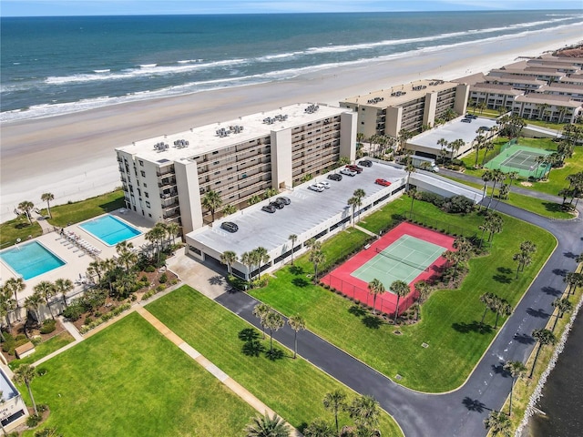 drone / aerial view featuring a water view and a view of the beach