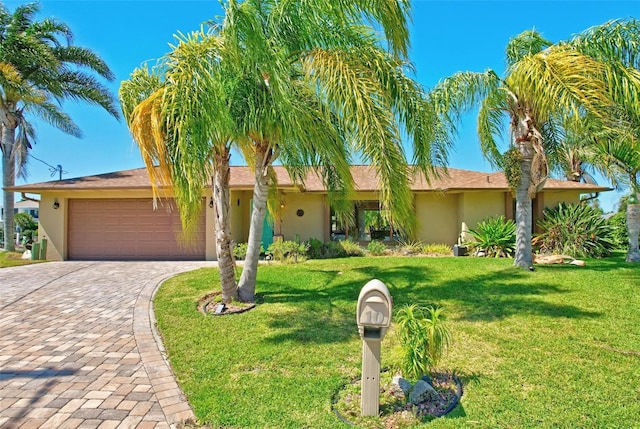 single story home with a front lawn and a garage