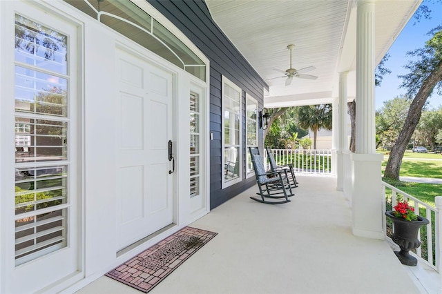 entrance to property featuring ceiling fan and a porch