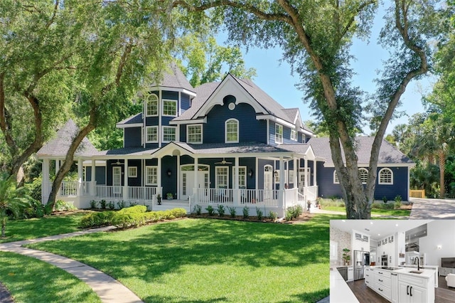 victorian home featuring a porch, a front lawn, an outdoor kitchen, and a sink