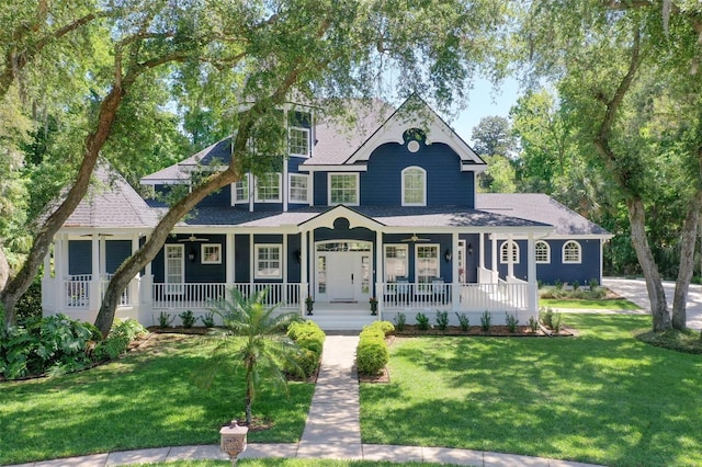 victorian home featuring a front lawn and a porch