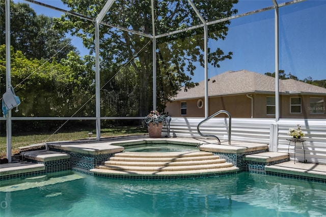 view of pool featuring a lanai and an outdoor hot tub