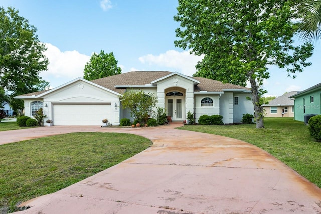 ranch-style home with a garage and a front lawn