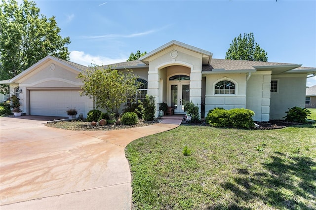 ranch-style home with a garage and a front lawn