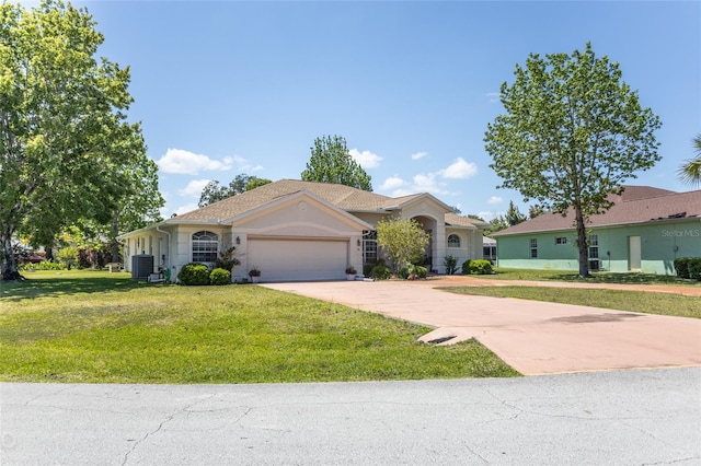 ranch-style house featuring a front lawn, a garage, and central AC