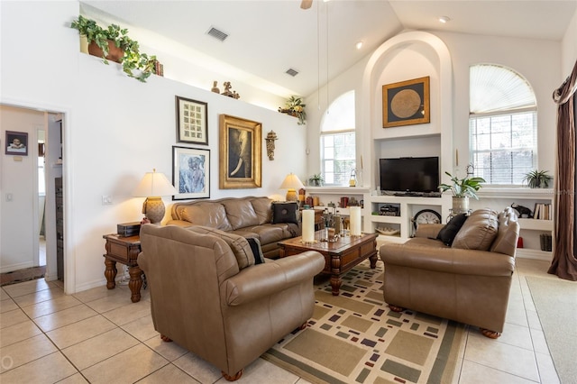 living room with built in features, high vaulted ceiling, and light tile flooring