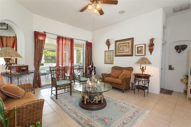 tiled living room with ceiling fan