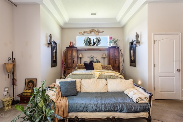 carpeted bedroom featuring a tray ceiling