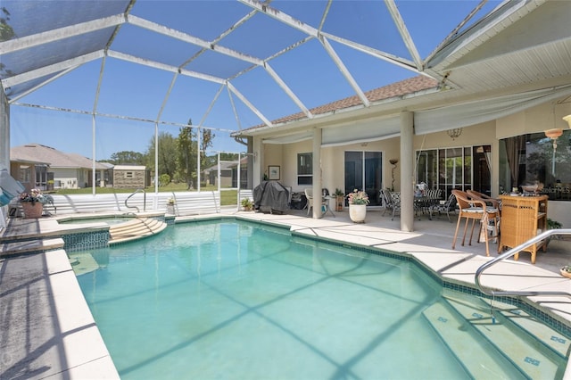 view of pool with a patio area, an in ground hot tub, and glass enclosure