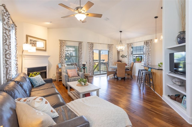 living room featuring ceiling fan with notable chandelier, dark hardwood / wood-style floors, lofted ceiling, and built in features