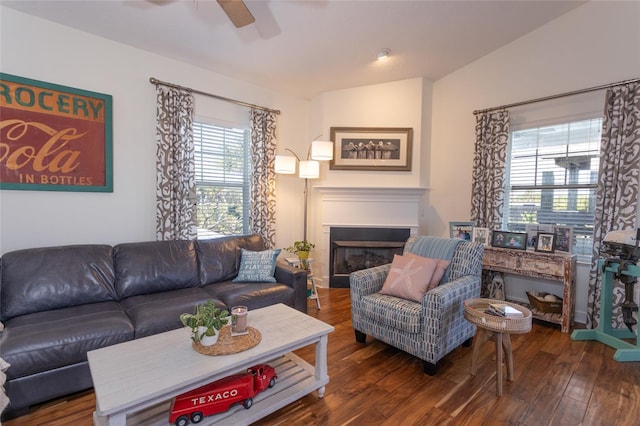 living room featuring ceiling fan, dark hardwood / wood-style floors, and vaulted ceiling