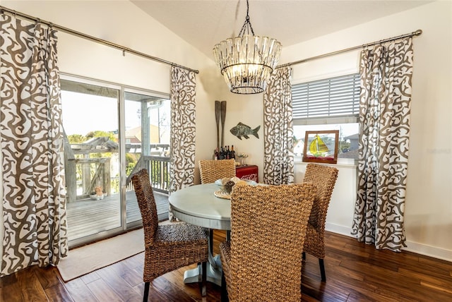 dining area featuring a notable chandelier, a wealth of natural light, lofted ceiling, and dark hardwood / wood-style floors