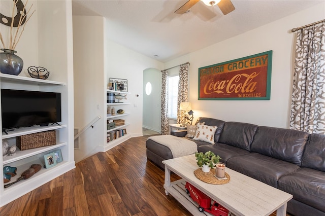 living room featuring dark hardwood / wood-style floors, ceiling fan, lofted ceiling, and built in shelves