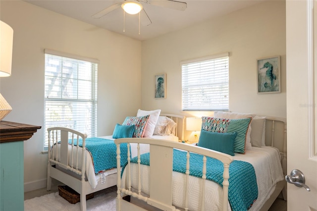 bedroom featuring multiple windows, carpet, and ceiling fan