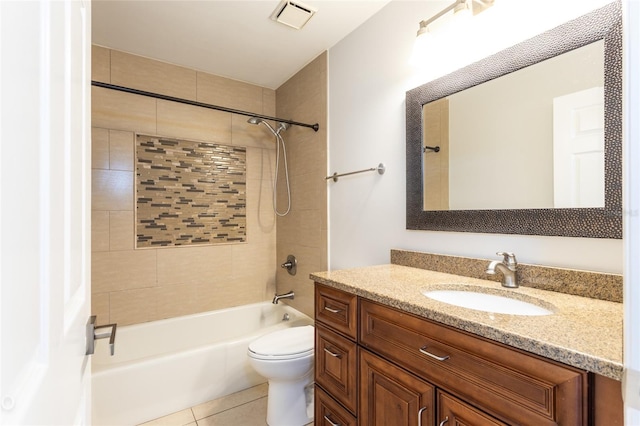 full bathroom featuring tile patterned floors, toilet, tiled shower / bath combo, and vanity