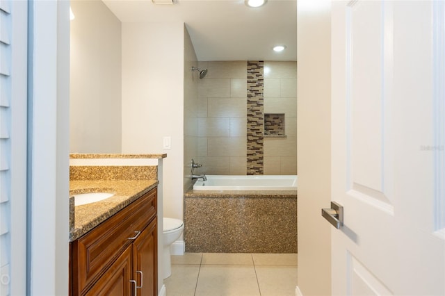 full bathroom with tile patterned flooring, vanity, tiled shower / bath combo, and toilet