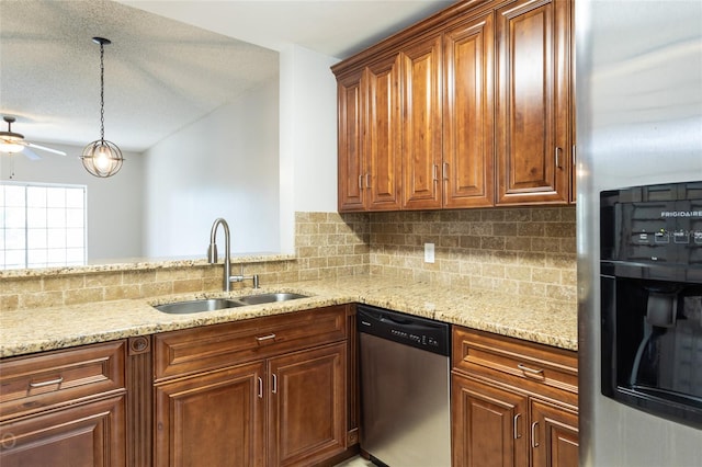 kitchen featuring sink, light stone counters, pendant lighting, stainless steel appliances, and backsplash