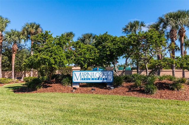 community / neighborhood sign with a lawn